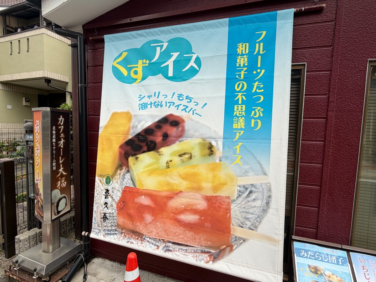 喜久春の軒先に掲げられたくずアイスを紹介する大きな幕