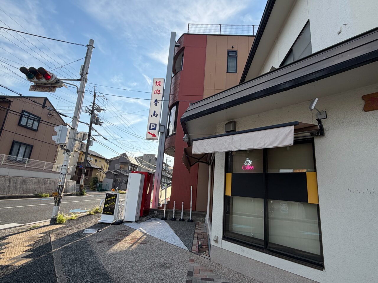 焼肉青山の建物と道路沿いに掲げられた縦長の看板